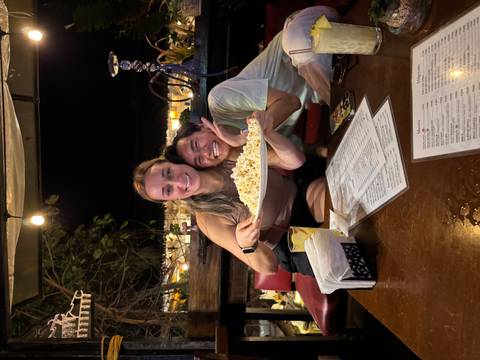 Two people enjoying food at a restaurant table.