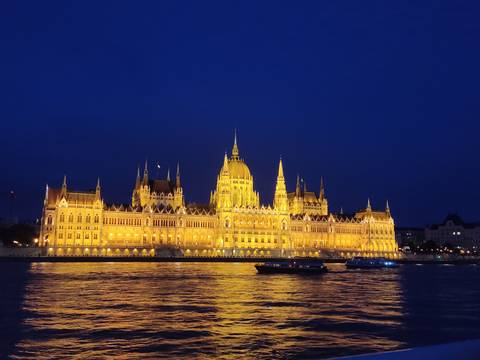 Hungarian Parliament Building illuminated at night.