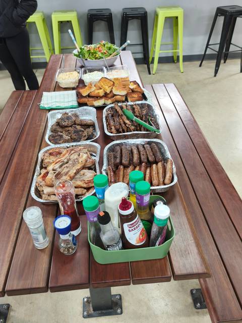       Variety of grilled meats and sauces on a table.
  