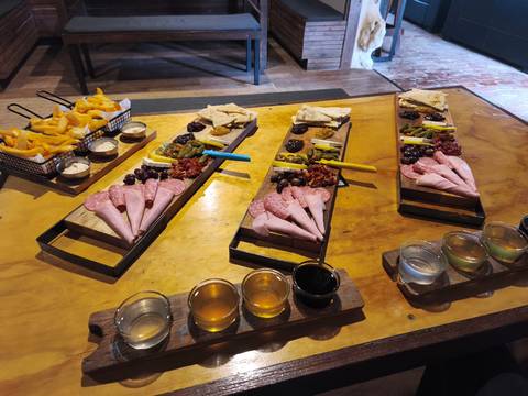       Plates with various deli meats and drinks on a table.
  