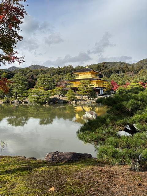 Golden Pavilion amidst a serene pond and lush greenery.