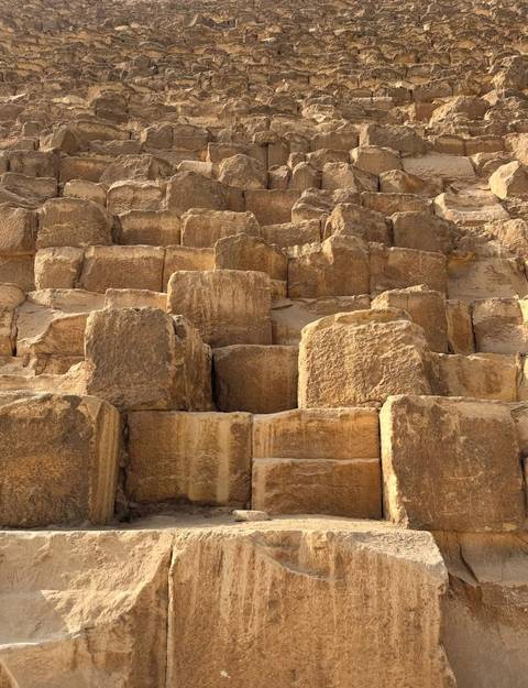       Close-up of ancient stone blocks forming part of a pyramid.
  