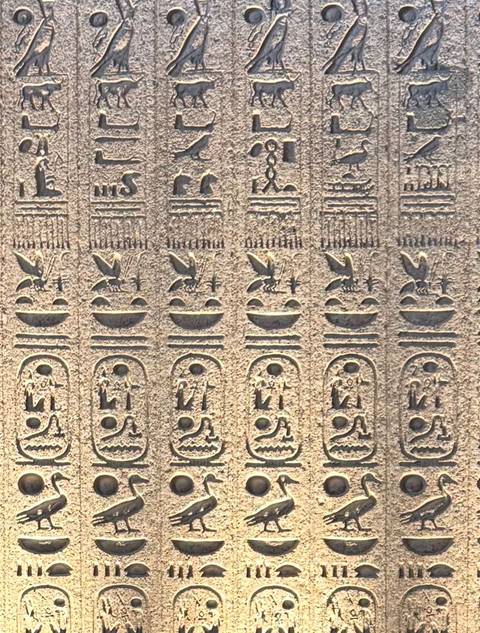       Wall adorned with ancient Egyptian hieroglyphs.
  