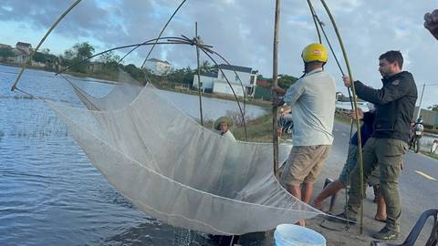       Local fishermen with nets in Vietnam.
  