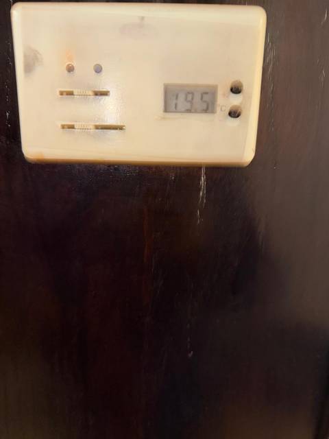       Texture and design detailing on a dark wood panel.
  