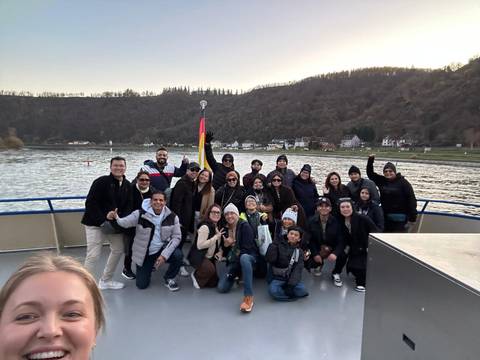Group of tourists on a boat with a German flag.