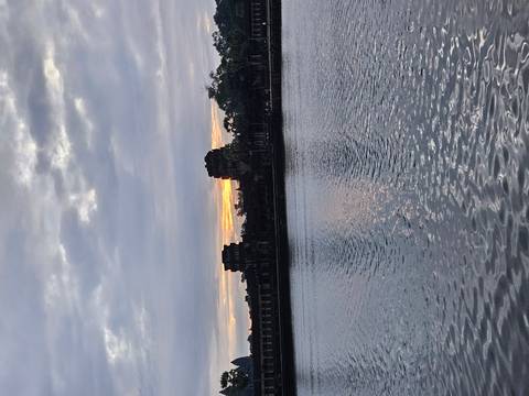 Sunset view over the water with historic structures.