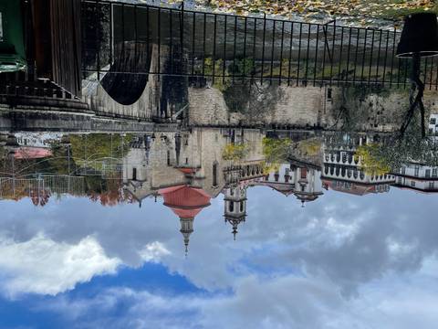 Historic buildings and bridge over a river.