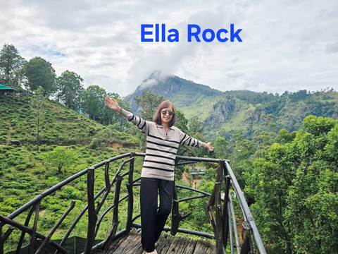 A woman posing on a railing with a mountain view, overlay text present.