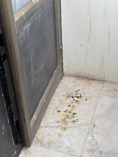 Dirty floor with stains near a door frame.