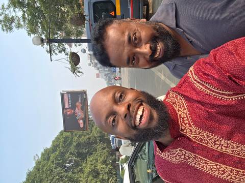       Two men taking a selfie on a street
  