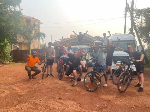 Group of cyclists posing with their bicycles.