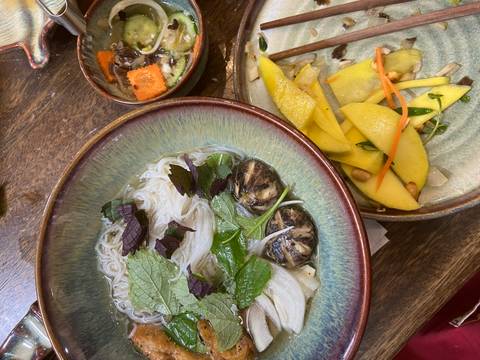       Vietnamese food dishes on a wooden table.
  