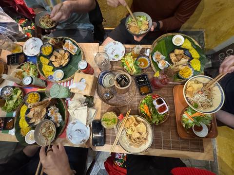 A table full of Vietnamese dishes seen from above.