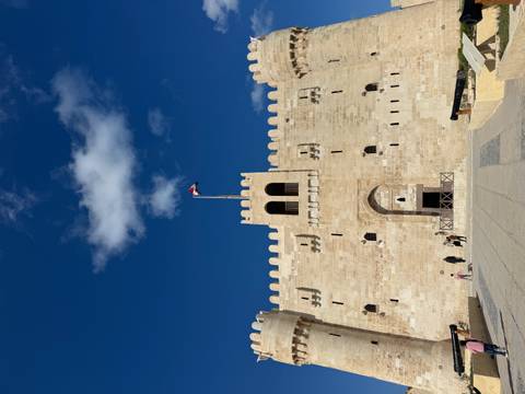 Large stone fortress with a flag on top.