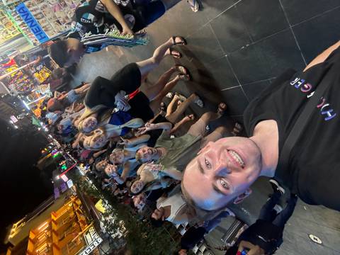 Group of people at a bustling night market street.