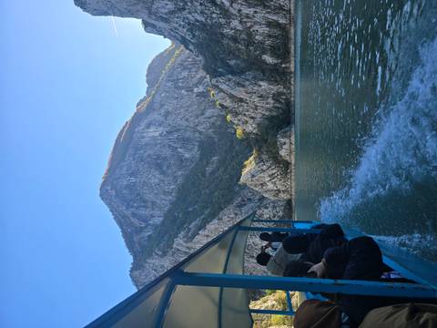 View from a boat on a river with rocky mountains.