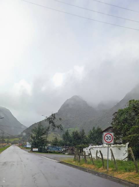       Cloudy mountain landscape with lush greenery.
  