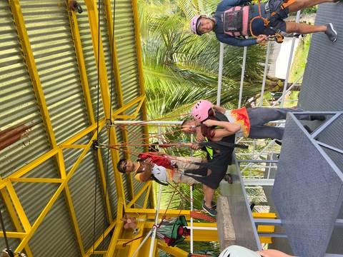       A person being prepared for a zipline adventure.
  