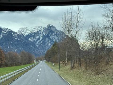       Scenic road view with mountains in the background.
  