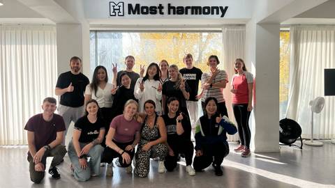 Group photo in a modern studio setting.
