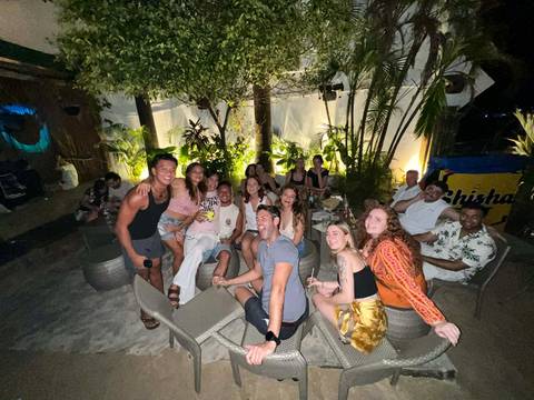       Group of people gathered in an outdoor social setting.
  