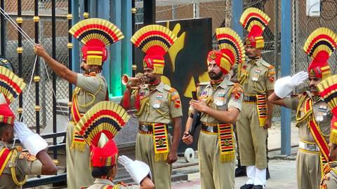 Group of soldiers in ceremonial attire with vibrant headgear.