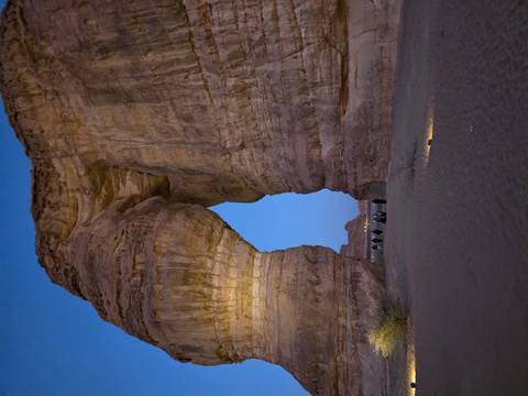 Elephant Rock in a desert landscape with people nearby.