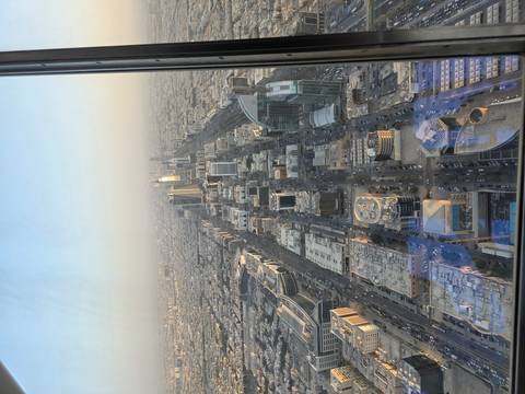 Aerial view of a city with modern skyscrapers and wide streets.