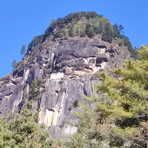Distant view of a monastery on a mountainside.