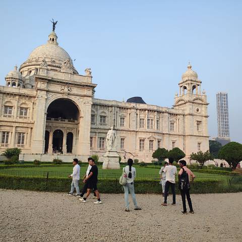 Historic grand building with people walking in the foreground.