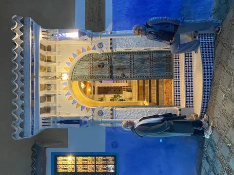 Two people by a beautifully lit arched doorway.