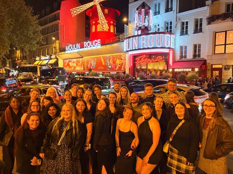 Group enjoying nightlife at the Moulin Rouge.