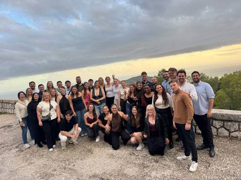 Large group posing on a viewpoint terrace.