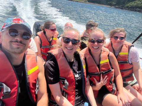 Group on a boat enjoying a sunny day.