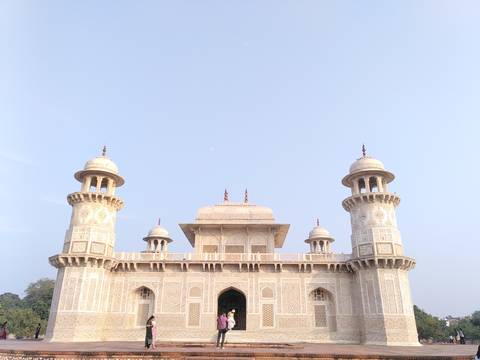 Historic white marble mausoleum with intricate carvings.