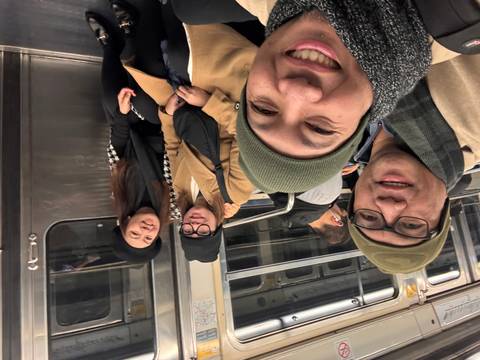       Group of people sitting inside a train.
  