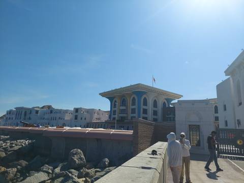       Buildings with a mountainous backdrop under a clear blue sky.
  
