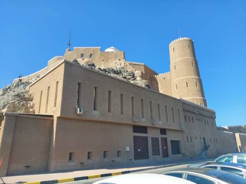 Large fort-like building under the bright blue sky.
