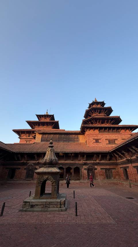       Traditional architecture with tiered roofs under a clear sky.
  