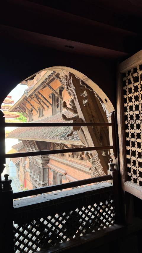       View through a window frame of traditional architecture.
  