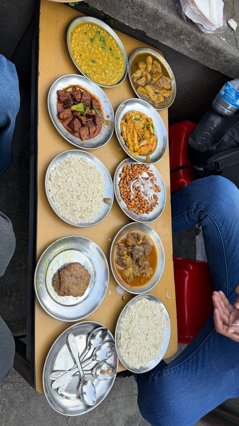       Assortment of traditional dishes served on silver plates.
  
