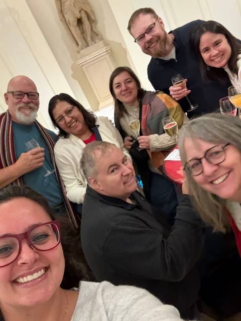       Friends enjoying drinks and socializing at an indoor event.
  