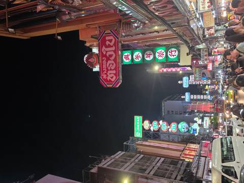 Busy street with illuminated signs at night.