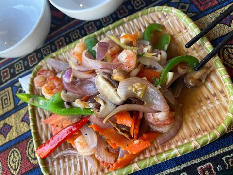 A colorful plate of shrimp and vegetables.
