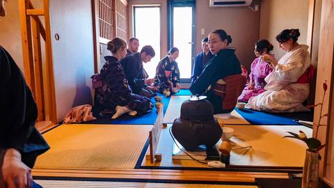 Traditional Japanese tea ceremony with participants in kimonos.