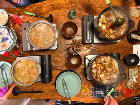       Variety of hotpot dishes on a wooden table.
  