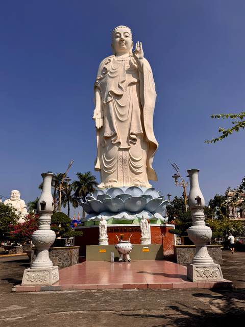 Large stone statue in a temple garden.