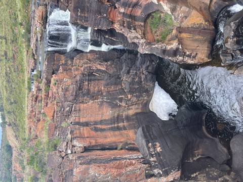       Scenic waterfall flowing through deep canyon.
  