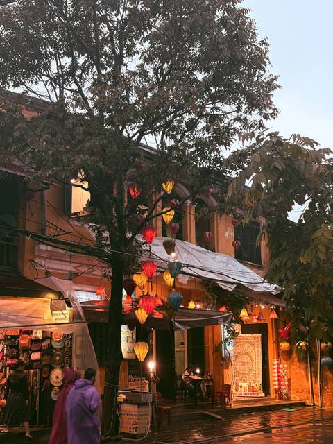      Charming building with colorful lanterns at dusk.
  